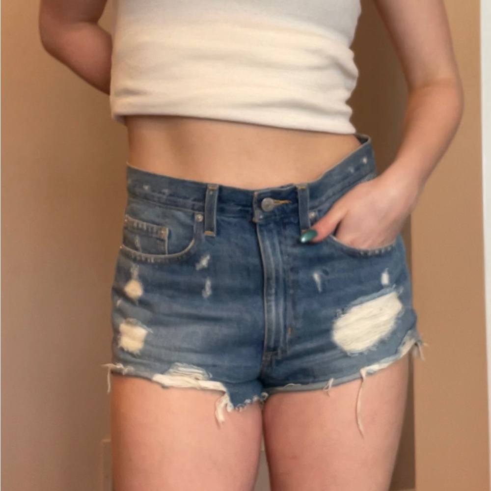 Distressed Medium Wash Denim Cut-Off Zip Shorts from BDG.